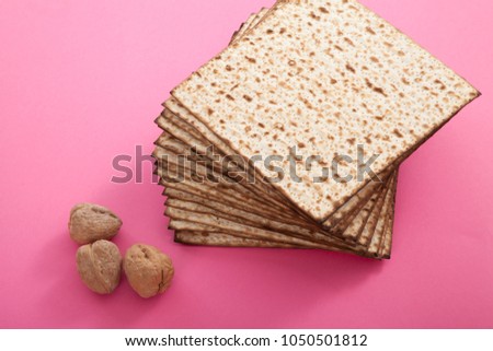 pile of matzoh bread and walnuts on pink studio background