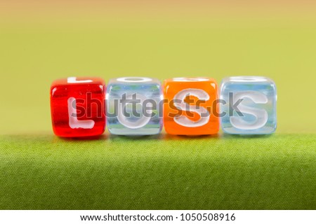 color cube figure with word Loss on green book