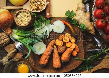 cooking from various vegetables, ingredients and spices. onion, eggs, potatoes. place for text on old paper. food background. Royalty-Free Stock Photo #1050556202