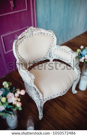 Vintage Sofa chair with flowers, interior in room in background concrete wall