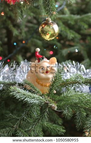 a picture of the New Year's plot. a Christmas tree with a toy figure of the symbol of 2019, a yellow earth pig. A beautiful and cozy New Year's picture.