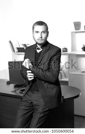 handsome young businessman in blue suit at office
