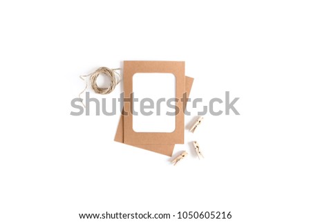 Styled minimal composition with kraft paper frame, wooden clothespins, twine on a white background