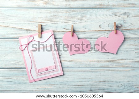 Greeting card with hearts on wooden background