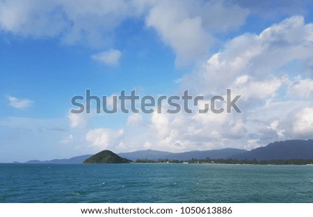 Photo of sea coast with hills and cloudy sky