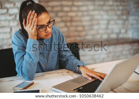 Young woman working on laptop and have problem