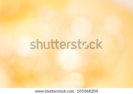 A soft glowing golden yellow bokeh background in landscape (horizontal) orientation. Royalty-Free Stock Photo #105068204
