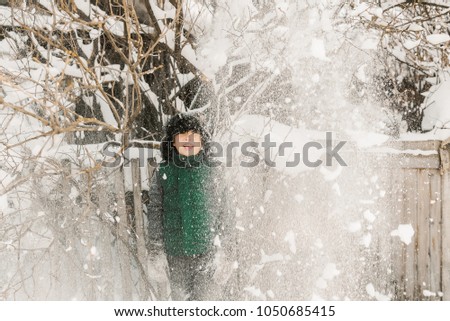 The boy in the village. Snowing