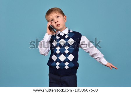 A young man communicates by mobile. Business conversation. A teenager has a telephone.