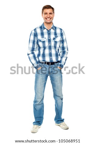 Full length portrait of fashionable young man standing with hands in pocket