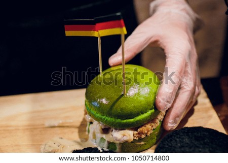 burger with green bun on wooden background