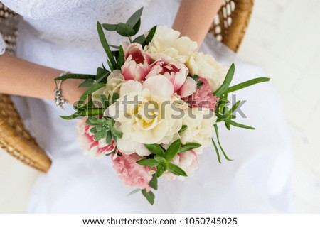 wedding bouquet with white yellow pink purple flowers in bridegroom hands and dress
