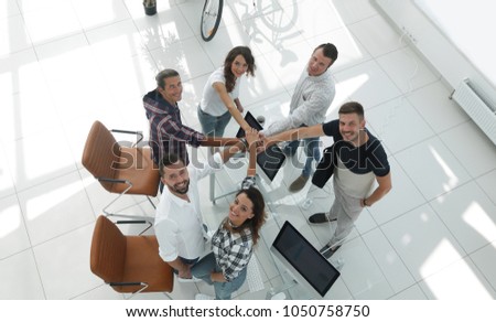 successful team with hands clasped togethe