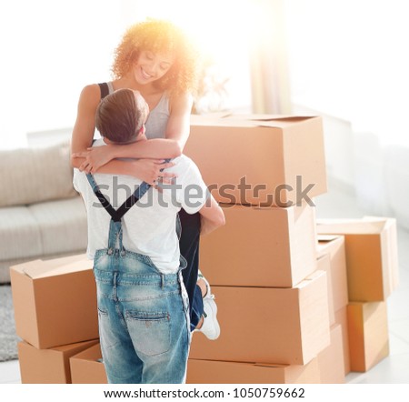 young couple hugging each other in new apartment.