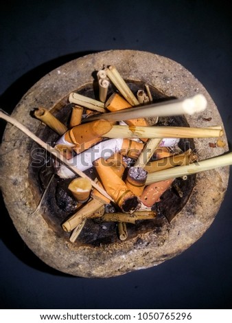 Cigarette butts in a bamboo ashtray