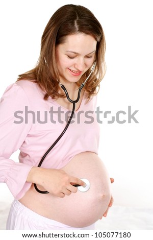 Caucasian pregnant woman with stethoscope on white background