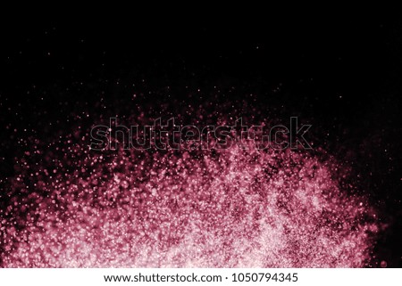 abstract Brown powder explosion on black background.abstract red powder splatted on black background. Freeze motion of red powder exploding.