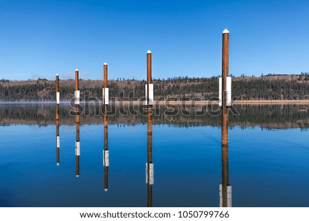 Calm lake landscape photo by the public docks in Harrison, Idaho.