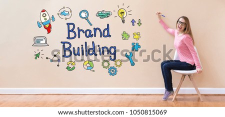 Brand Building with young woman holding a pen in a chair