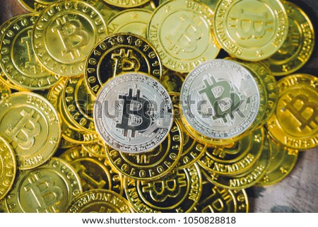 Many bitcoins laying all over wooden background
