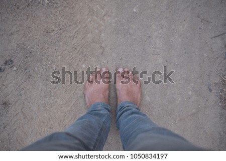 Looking down on feet and a wooden surface, space for text. selective focus