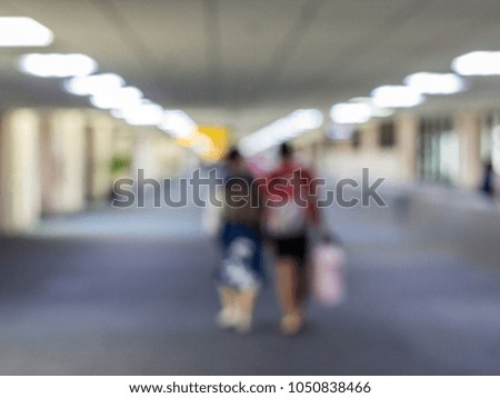 Abstract blur of colorful people in terminal gate at the airport. Blur of passenger walking on walkway in the airport.