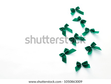 St Patricks Day side border of green bows over a white background