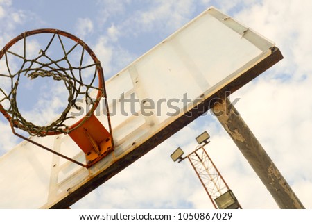 Basketball hoop in the park with blue sky as background. outdoor sport
