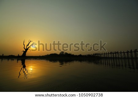 Silhouette of the sun is falling in the middle of the river.