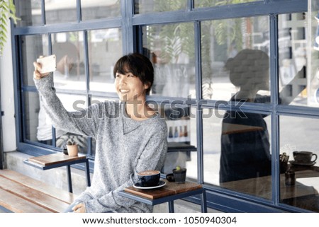 Asian women making selfie at cafe by her smartphone. Urban life 