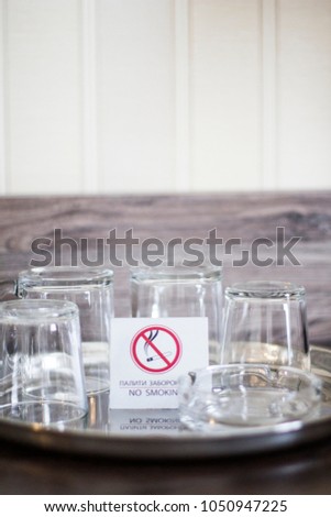Glass cups with a plate No smoking. Glasses in the Ukrainian hotel. No smoking. Glasses on a tray