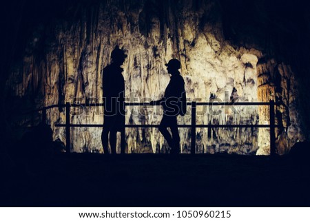 Silhouette of tourists visiting Baraceve spilje cave, Croatia.