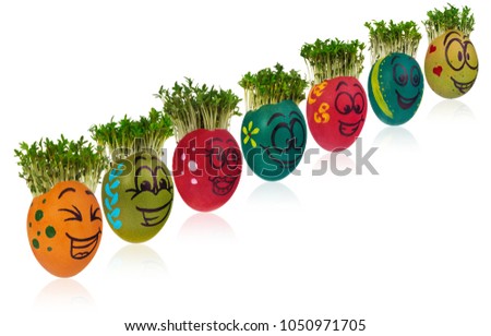 Easter egg painted in a funny smiley girl face and colorful patterns with cress like hair. The watercress stylized for the hairstyle of the character. Egg in red and orange colors on a white backgroun