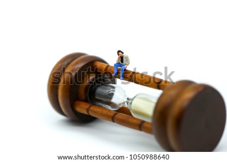 Miniature people : Man sitting on Sandglass, hourglass.
