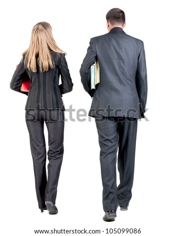 Back view of walking business team. Going young couple (man and woman) with books. beautiful girl and guy  together. Rear view people collection backside view of person. Isolated over white background