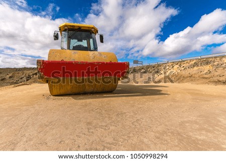 Steamroller smoothing a road in a desert