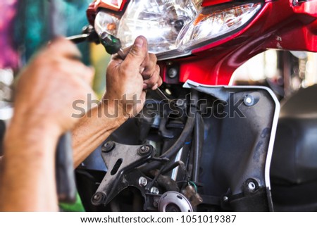 Mechanic fixing motorcycle