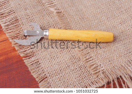 can opener on a wooden background