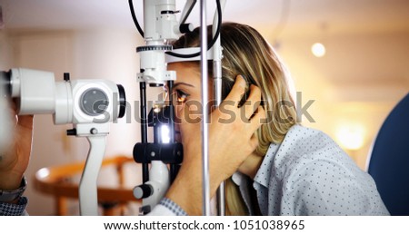 optometrist checking patient eyesight and vision correction Royalty-Free Stock Photo #1051038965
