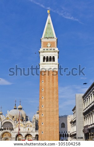 San Marco Campanile (bell tower of Saint Mark Basilica) on Piazza San Marco. Campanile - one of famous symbols in Venice, at its top located a cube, which shows Lion of St. Mark and symbol of Justice