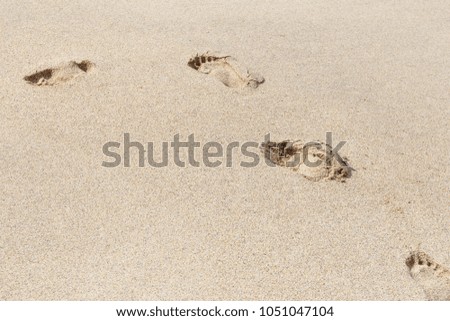 Footprints in sand on Cornish Beach