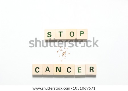 words stop cancer made of wooden  block and some tobacco isolated on white background