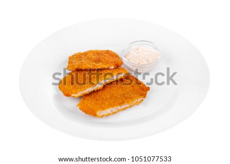 Schnitzel is cut into pieces of chicken, pork, meat, grilled, barbecue, on plate isolated white background. Tartar, sour cream, mayonnaise, white sauce. For the menu in the restaurant, bar. Side view Royalty-Free Stock Photo #1051077533