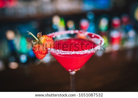 Refreshed Margarita cocktail with strawberry on the bar desk. This is summer exotic colorful cocktail