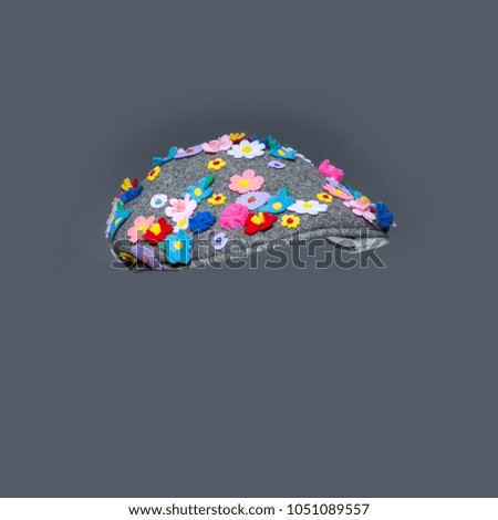 Floral spring mood. Funny spring cap isolated over gray