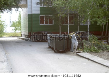 Garbage container in the city street. Summer background 