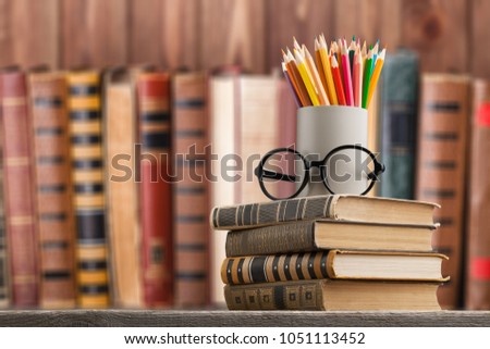 Books stack with colorful pencil