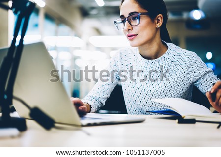 Experienced businesswoman reading publication via laptop computer making research for planning startup at desktop,female secretary checking mail on netbook organizing working process in office Royalty-Free Stock Photo #1051137005