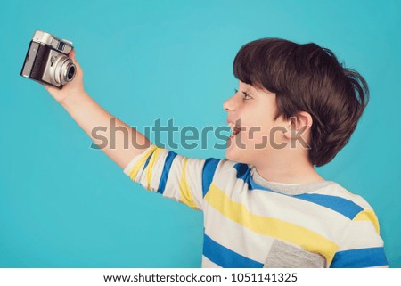 Smiling child taking selfie photo
