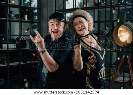Happy couple of retirees in biker clothes.Unusual retired couple.Biker man and biker woman.Happy pensioners